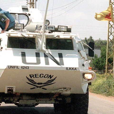 A UNIFIL personnel carrier drives by a picture of late Hezbollah leader Sheikh Abbas al-Mussawi May 2, 2000, in the village of Ghandourieyh in south Lebanon.