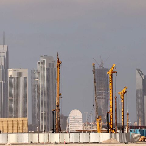 Cranes are used at a construction site across from high-rise buildings in Dubai, on Feb. 18, 2023.