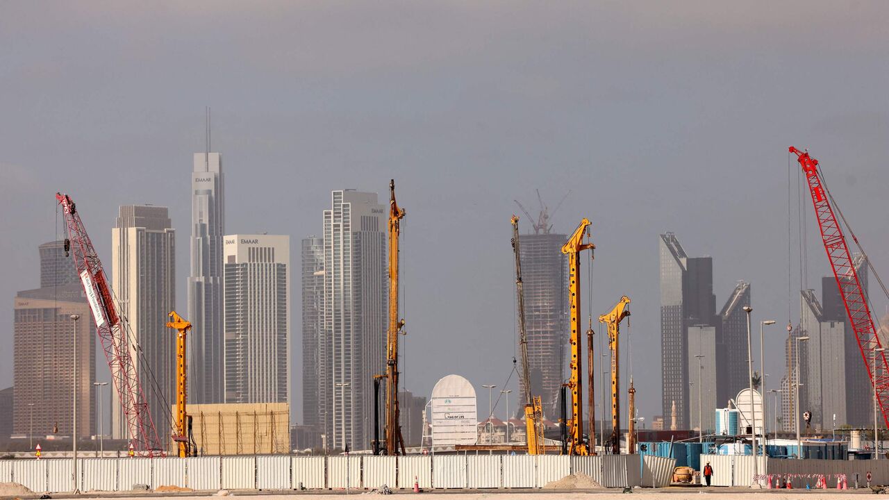 Cranes are used at a construction site across from high-rise buildings in Dubai, on Feb. 18, 2023.