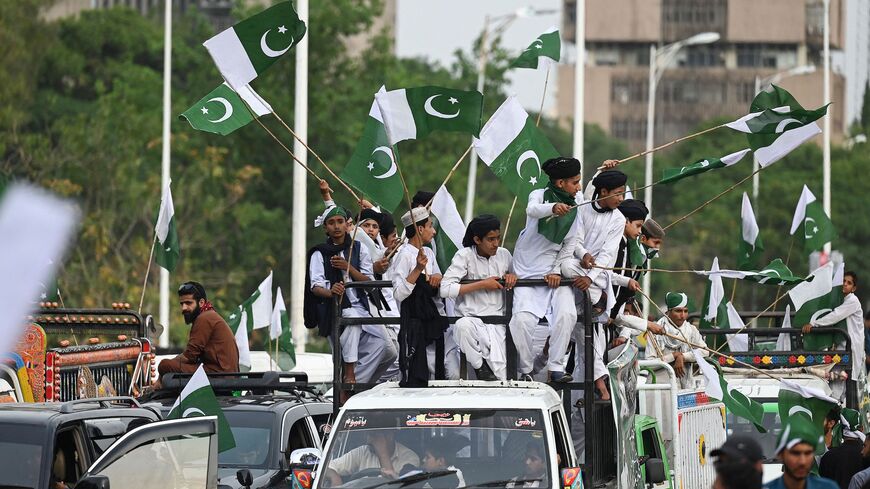 People carrying flags of Pakistan take part in a rally to show solidarity with Pakistan's army in Islamabad on May 17, 2023, after military installations were allegedly damaged by supporters of former Pakistan's prime minister Imran Khan following his arrest last week.