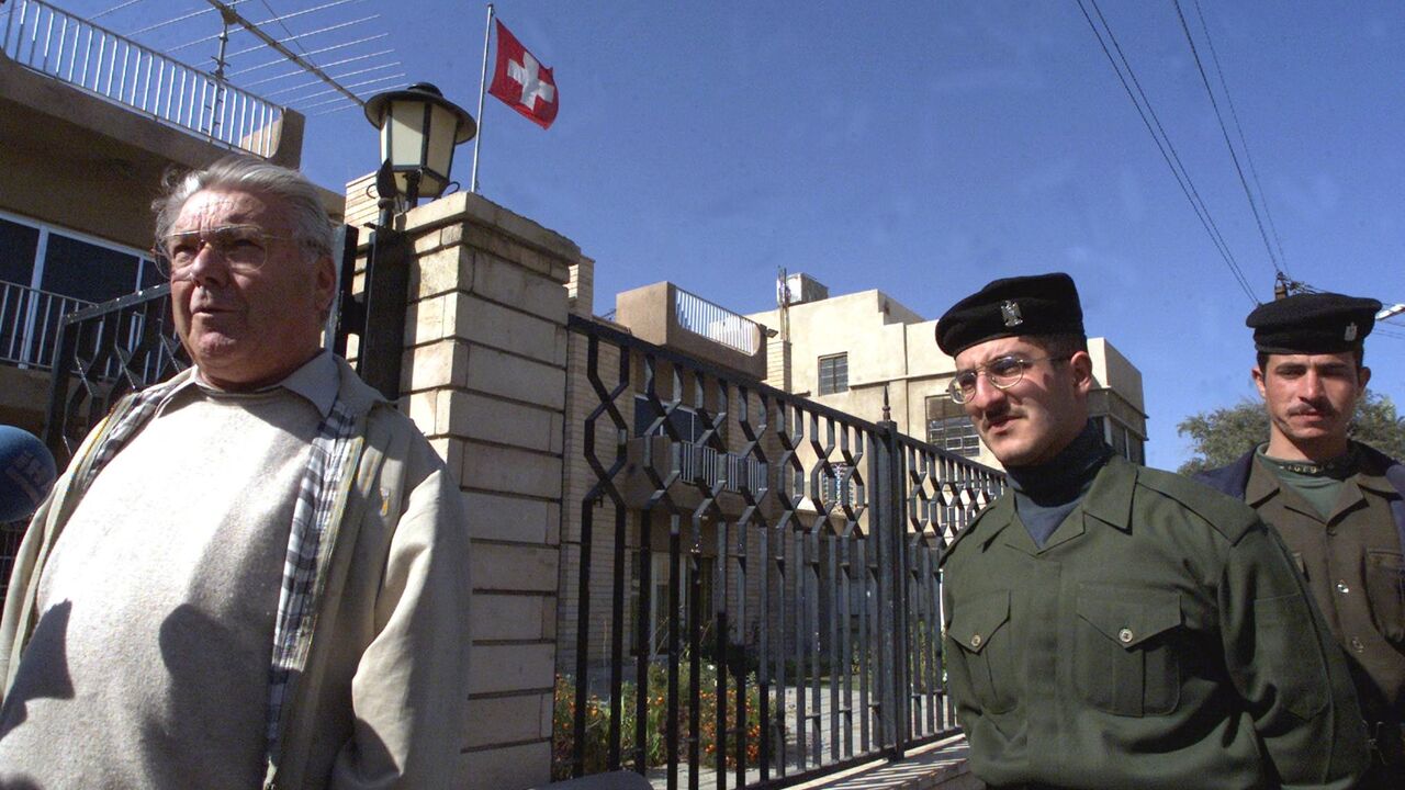 Kurt Reiniger, Swiss diplomat in charge of humanitarian affairs (L), arrives at the Swiss Embassy in Baghdad, on February 2, 2001.