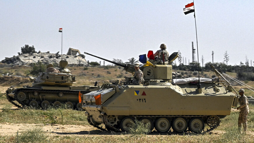 An Egyptian army M60 main battle tank and an infantry fighting vehicle (IFV) are deployed near the Egyptian side of the Rafah border crossing with the Gaza Strip on March 23, 2024, amid the ongoing conflict in the Palestinian territory between Israel and the Palestinian militant group Hamas.
