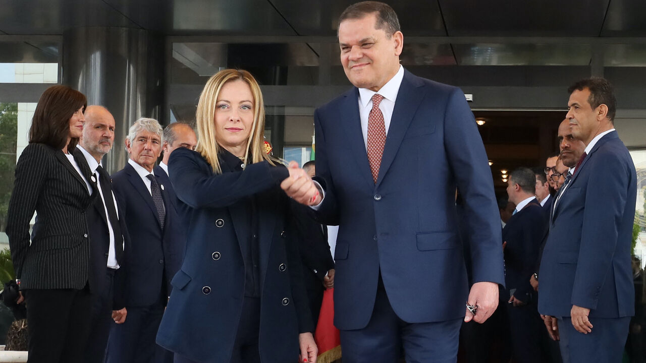Libya's interim Prime Minister Abdulhamid Dbeibah (R) welcomes Italy's Prime Minister Giorgia Meloni as she arrives for a meeting in Tripoli on May 7, 2024.