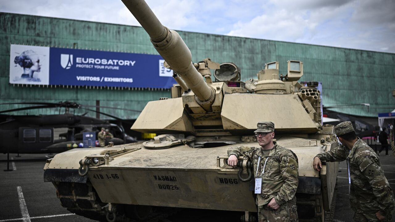 US marines lean on a Abraham tank during the Eurosatory international land, air defence and security trade fair, in Villepinte, a northern suburb of Paris, on June 17, 2024.
