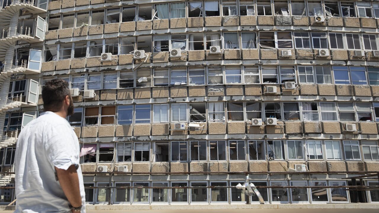 A man looks at a building damaged by a drone explosion that Houthis rebels in Yemen claimed responsibility for, Tel Aviv, July 19, 2024.