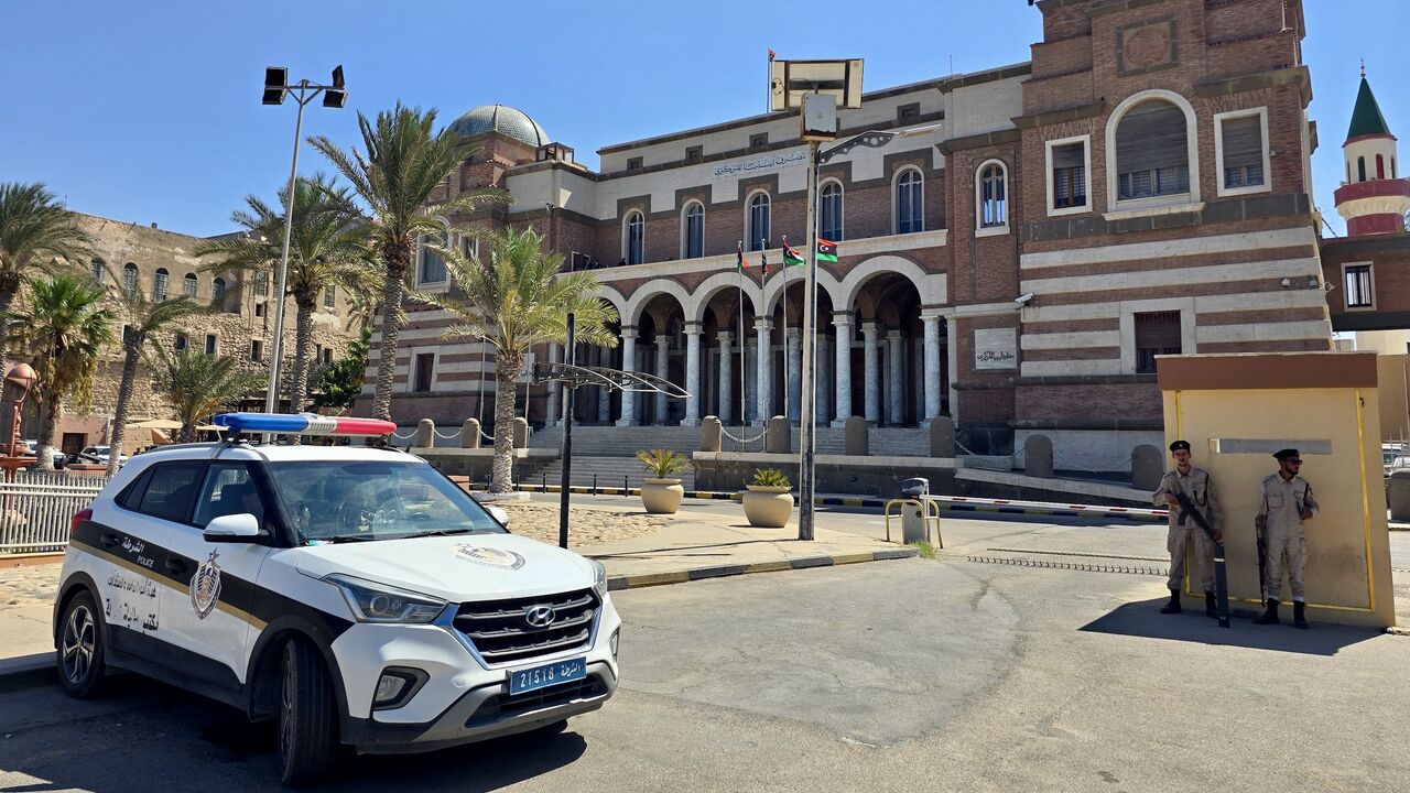 Police officers stand guard outside Libya's Central Bank headquarters in Tripoli on Aug. 27, 2024.