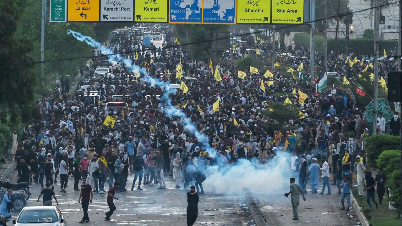 Members of Imamia Students Organization, a Shiite Muslim student wing, take part in a protest to condemn the killing of Hassan Nasrallah, as policemen fire tear gas shells to disperse them in Karachi on Sept. 29, 2024.