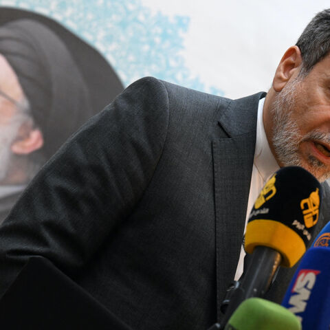 Iranian Foreign Minister Abbas Araghchi speaks to the press, in front of the portrait of slain Lebanese Hezbollah leader Hassan Nasrallah, after meeting with Syrian officials at the Iranian embassy in Damascus on Oct. 5, 2024.