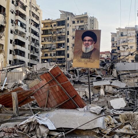 A portrait of slain Hezbollah leader Hassan Nasrallah sits amid debris at Beirut's southern suburb Rouweiss neighborhood on Oct. 10, 2024, following overnight Israeli strikes. 