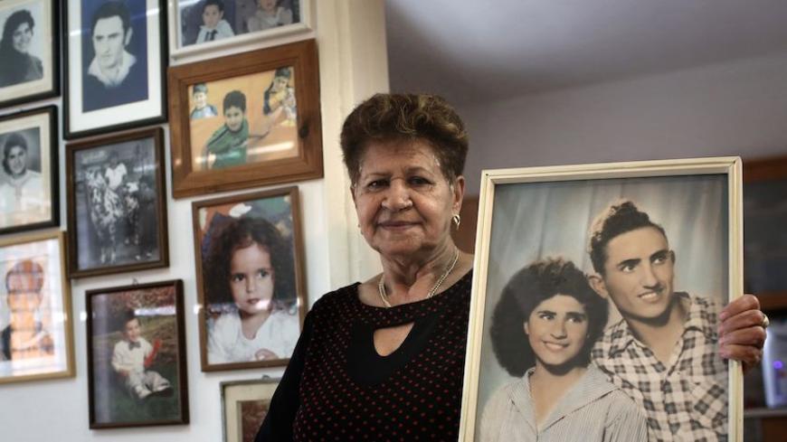 Yona Musa, 76, from a Yemeni descent, poses with a portrait of her and her husband on June 29, 2016 at her home in the Israeli city of Herzliya, near Tel Aviv. 
Musa is one of the thousands of Israelis, mainly from Jewish Yemenite families, who claim their babies were abducted more than 60 years ago and handed to adoption. Such stories of babies from immigrant families disappearing have been told in Israel for decades, but growing calls to unseal official documents on the allegations mean new light could so