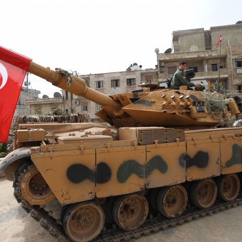 A tank belonging to Turkish soldiers and Ankara-backed Syrian Arab fighters is seen in the Kurdish-majority city of Afrin in northwestern Syria after they took control of it from Kurdish People's Protection Units (YPG) on March 18, 2018.
Turkish-backed rebels have seized the centre of Afrin city in northern Syria, Ankara said, as they made rapid gains in their campaign against Kurdish forces. A civilian inside Afrin said that rebels had deployed in the city centre and that the Kurdish People's Protection Un