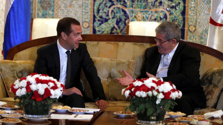 Algerian Prime Minister Ahmed Ouyahia meets his Russian counterpart Dmitry Medvedev upon his arrival at Algiers airport, Algeria October 9, 2017. Picture taken October 9, 2017. Sputnik/Dmitry Astakhov/Pool via REUTERS ATTENTION EDITORS - THIS IMAGE WAS PROVIDED BY A THIRD PARTY. - RC1CBAD54670