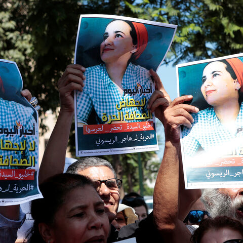 Moroccan activists hold the poster of Hajar Raissouni, a journalist charged with fornication and abortion, during a protest outside the Rabat tribunal, Morocco September 9, 2019. REUTERS/Youssef Boudlal - RC16585AAC30