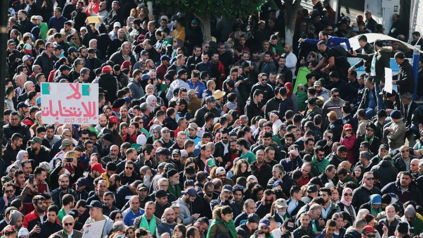 Demonstrators shout slogans during a protest to reject the presidential election in Algiers, Algeria December 12, 2019. REUTERS/Ramzi Boudina - RC2QTD9ZGJA7