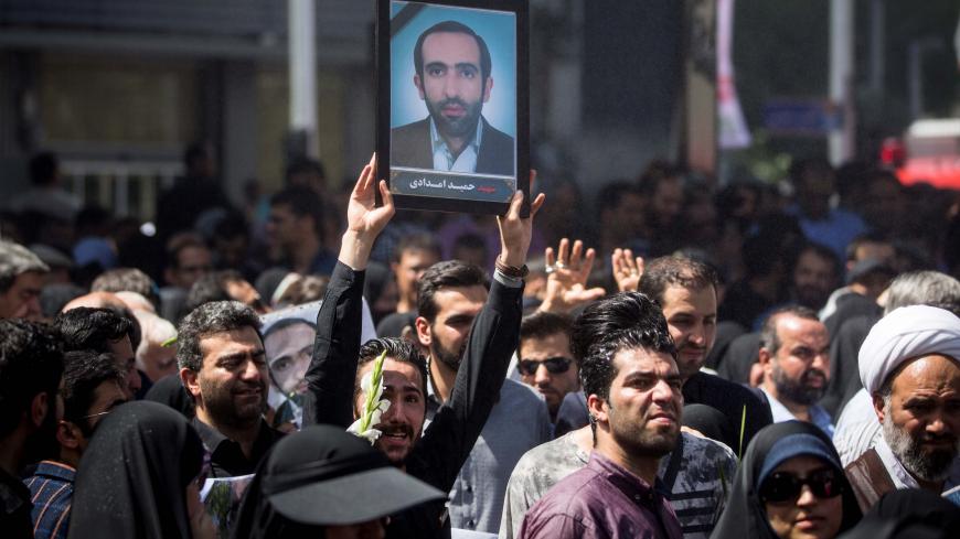 People attend the funeral of the victims who were killed on the June 7 attack at the Iranian parliament and Ayatollah Khomeini's mausoleum, in Tehran, Iran June 9, 2017. TIMA via REUTERS  ATTENTION EDITORS - THIS IMAGE WAS PROVIDED BY A THIRD PARTY. FOR EDITORIAL USE ONLY? - RTX39TEM