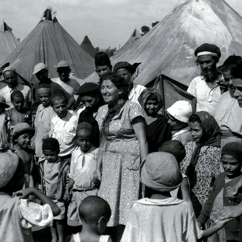 FILE PHOTO 1OCT49 - Jewish immigrants from Yemen in a tent encampment in 1949 as they are visited by Israeli nurses. Many Jewish immigrants of Sephardic origin from North Africa and the Middle East were shipped to Israeli development town when they arrived, while many of the European, or Ashkenazi, immigrants were able to start their new lives in Israel's cities with promising jobs. Most of the Yemenites arrived in Israel during "Operation Magic Carpet" in the late 1940's. In the 1950's and 60's some 300,00